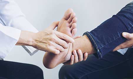 Chiropractor examines foot for cause of plantar fasciitis