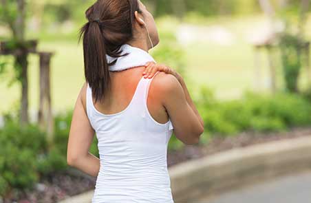 Woman suffering from shoulder pain