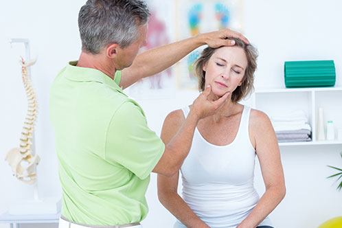 Chiropractor examining spine x-rays